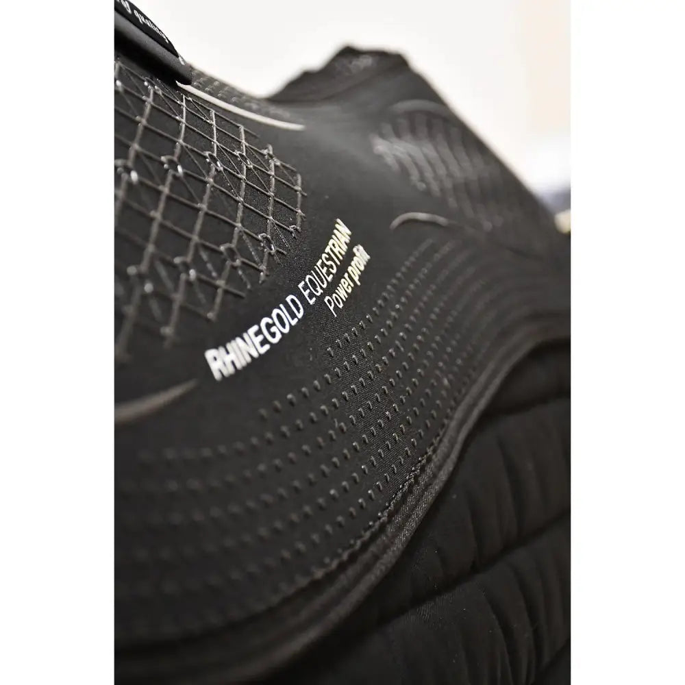 Black rhinegold equestrian power pro riding boot with textured mesh and padded sections paired with rhinegold silicone memory foam slim interchangeable saddle pad