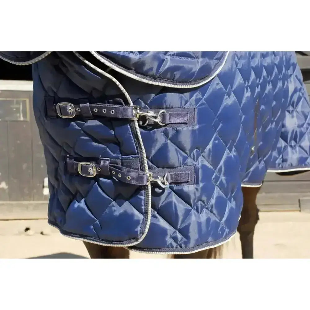 Navy blue quilted rhinegold texas diamond 300g stable rug with silver trim and adjustable straps for horses