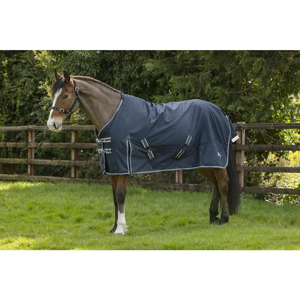 Navy blue rhinegold turnout rugs arizona 100g light with white trim and reflective straps for safety and comfort