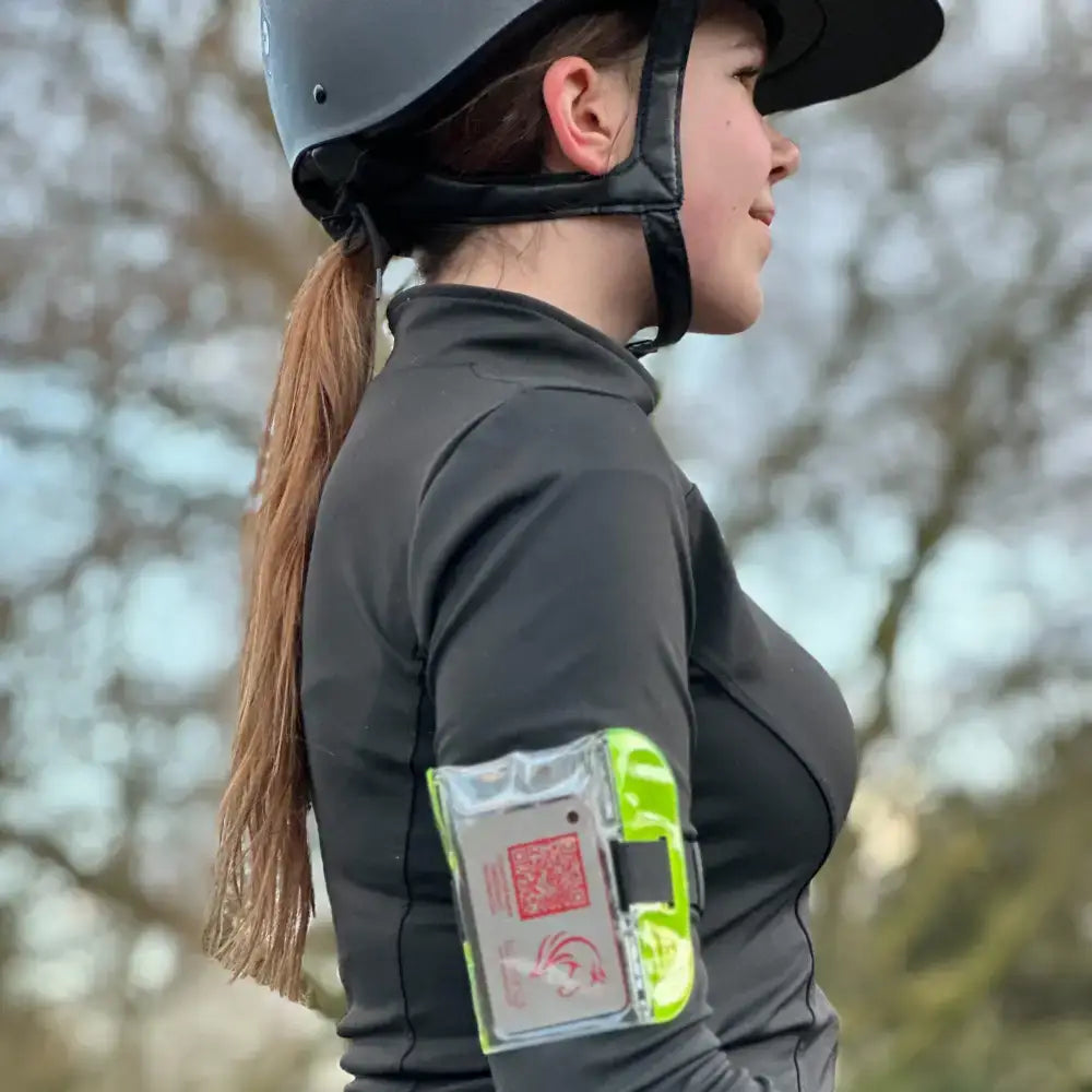 Bright neon green and clear plastic rider emergency tag armband with red logo showing emergency contacts and medical details