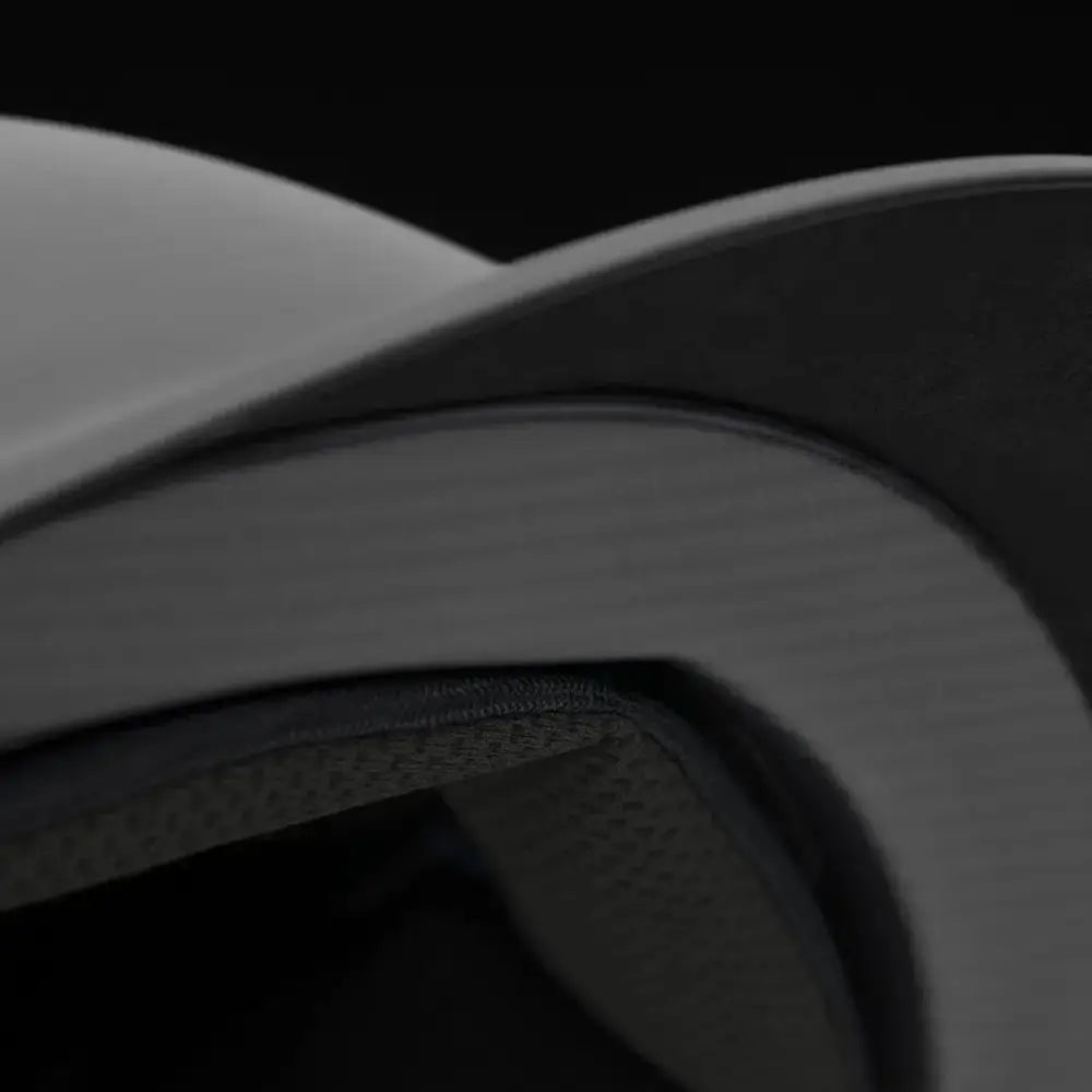White curved cap brim with a smooth surface on samshield shadowmatt riding hats featuring chrome blazon and trim