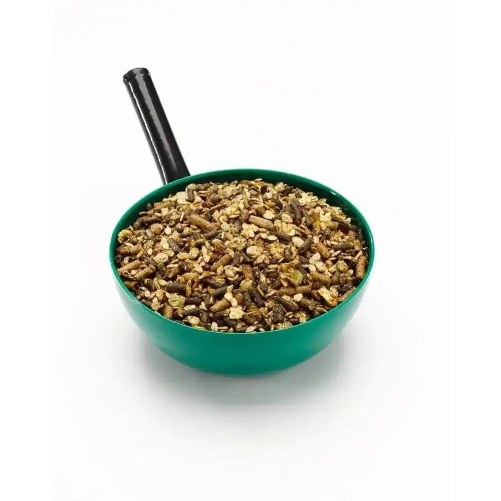 Green plastic scoop filled with brown and tan pellets of saracen cooling mix pony cooling mix for horses
