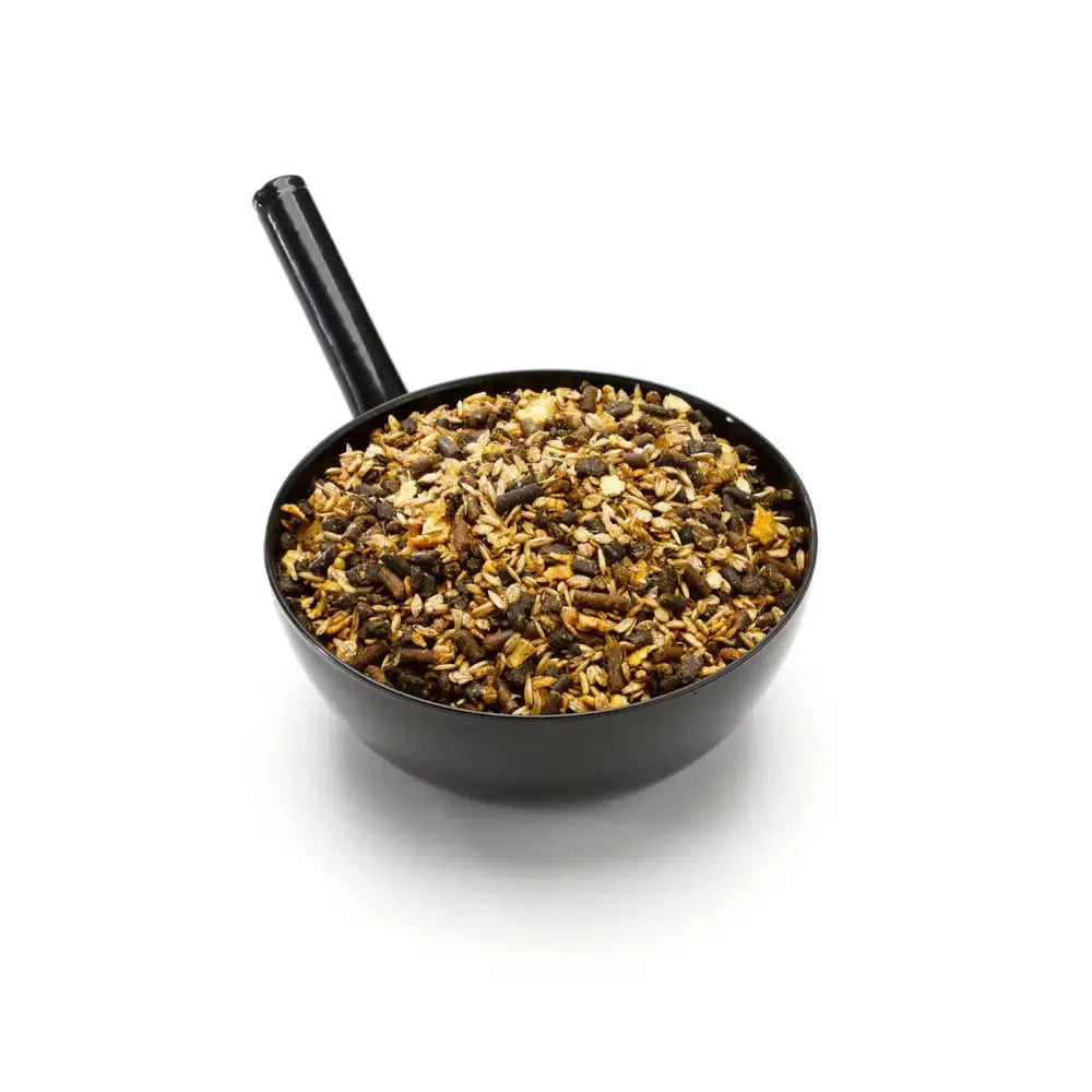 Black plastic measuring cup filled with brown tan mix of chelated minerals for equine athlete saracen enduro-performance