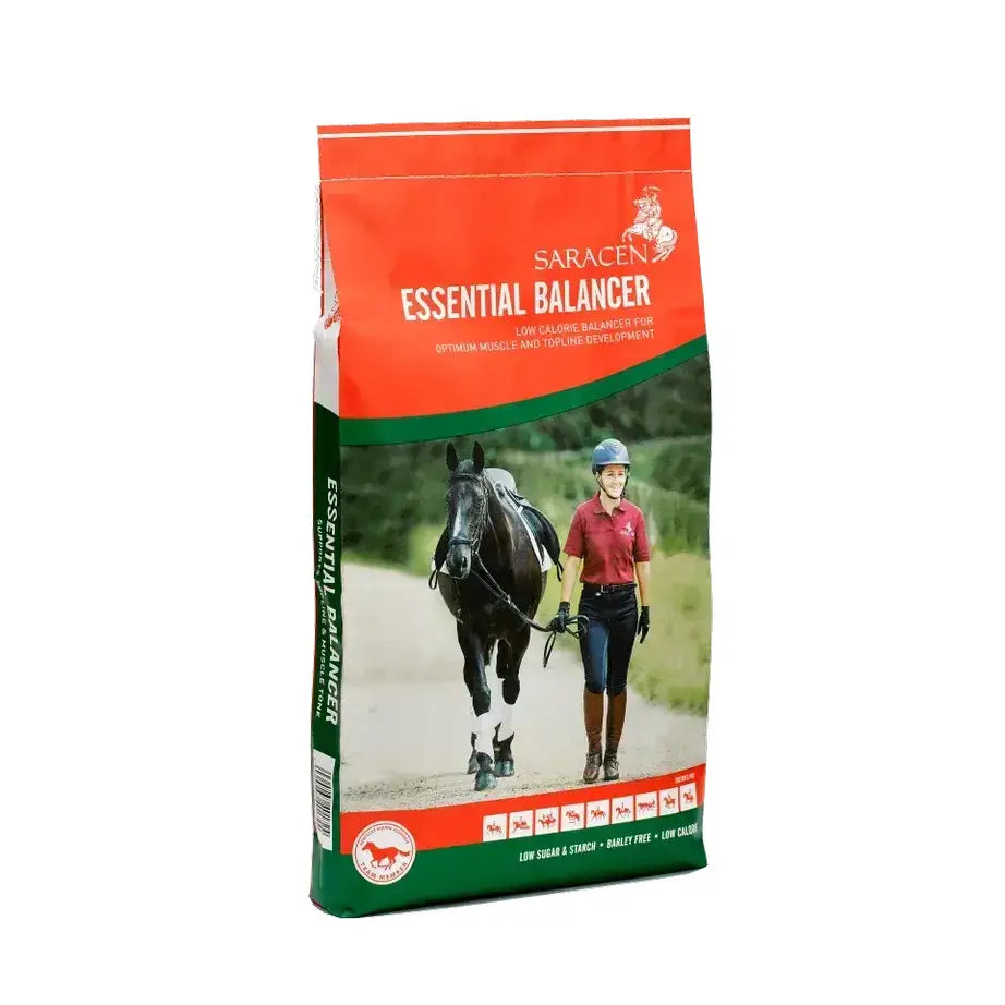 Saracen essential balancer 20 kg horse feed bag with red green design and rider walking beside black horse image