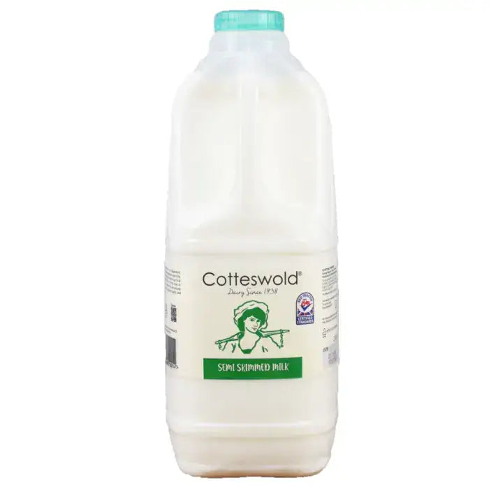 A white plastic bottle of cotteswold semi skimmed milk with a teal cap and green vintage label for milk cotteswold