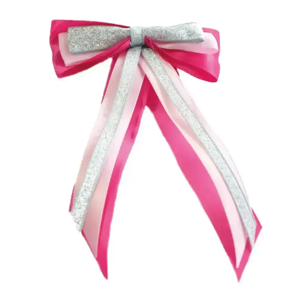 A vibrant pink and silver glittery showquest hairbow with layered satin tails perfect for finishing showring touch