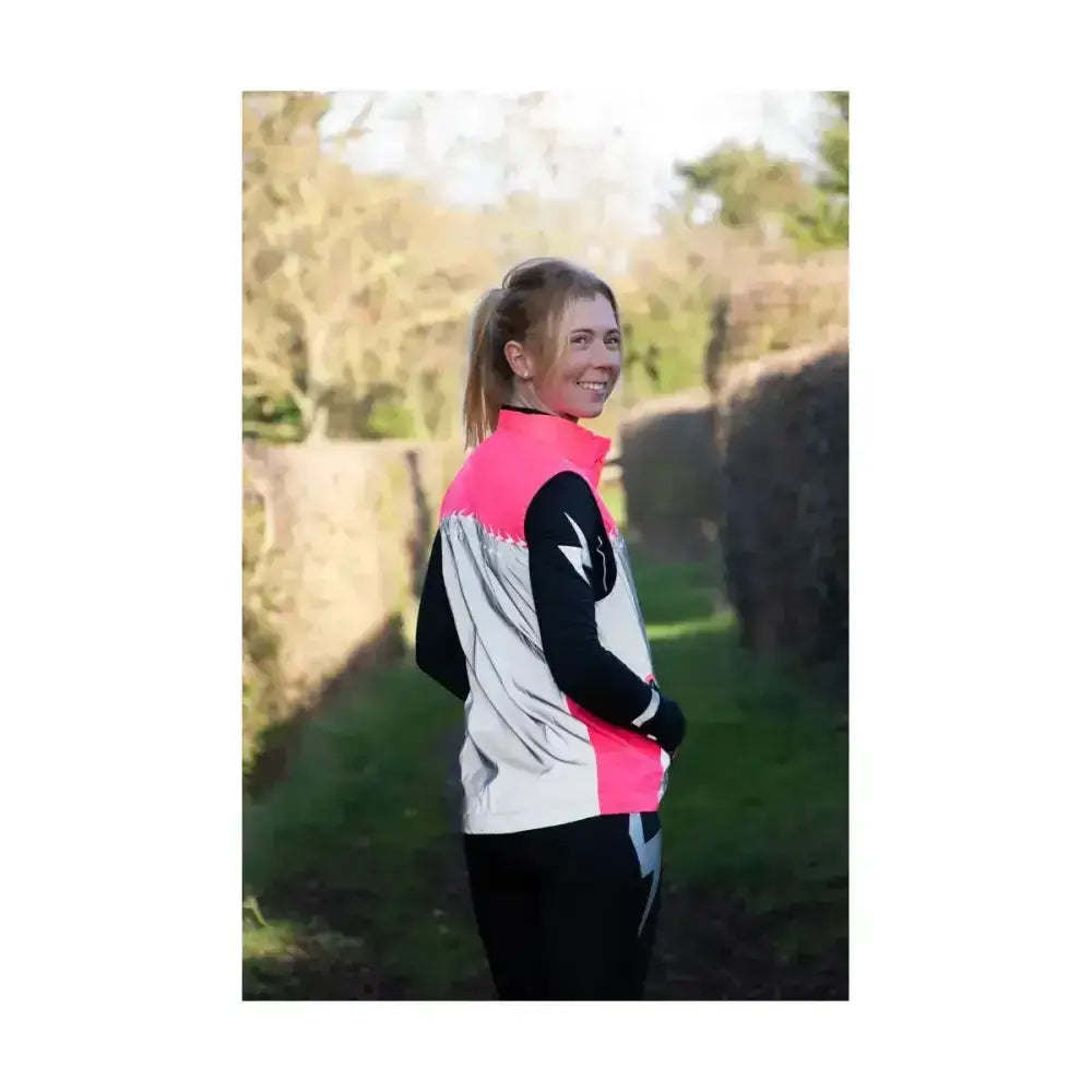 A vibrant pink black and silver silva flash lightweight duo reflective gilet with a bold lightning bolt design on the sleeve