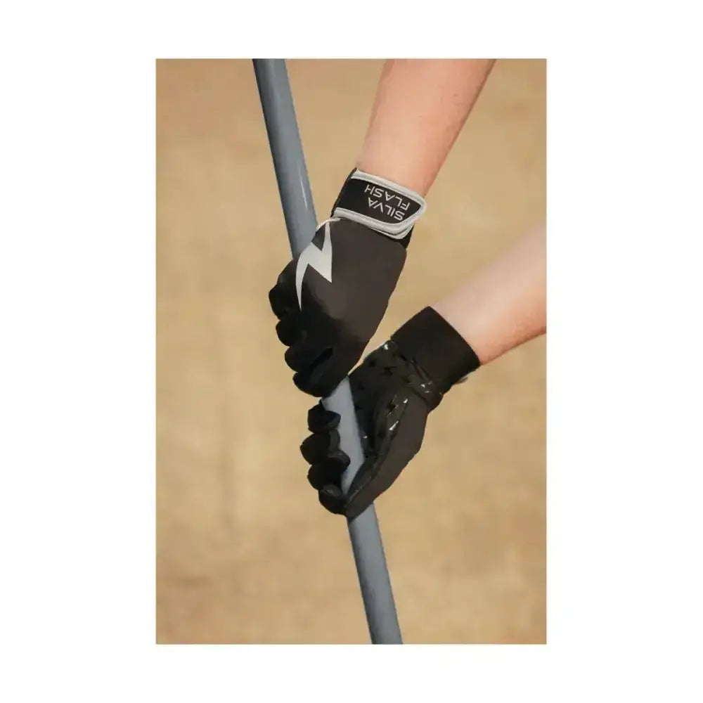 Black silva flash riding gloves with white lightning bolt and gray accents gripping a pole, wind resistant design