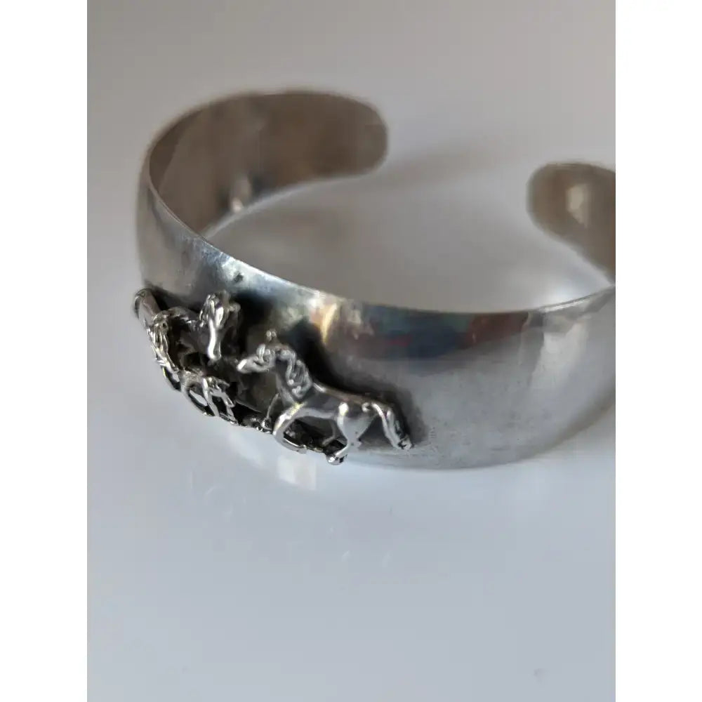 Silver steed herd bangle featuring a silver metal cuff bracelet with a 3d detailed horse figurine design perfect for equestrian jewelry
