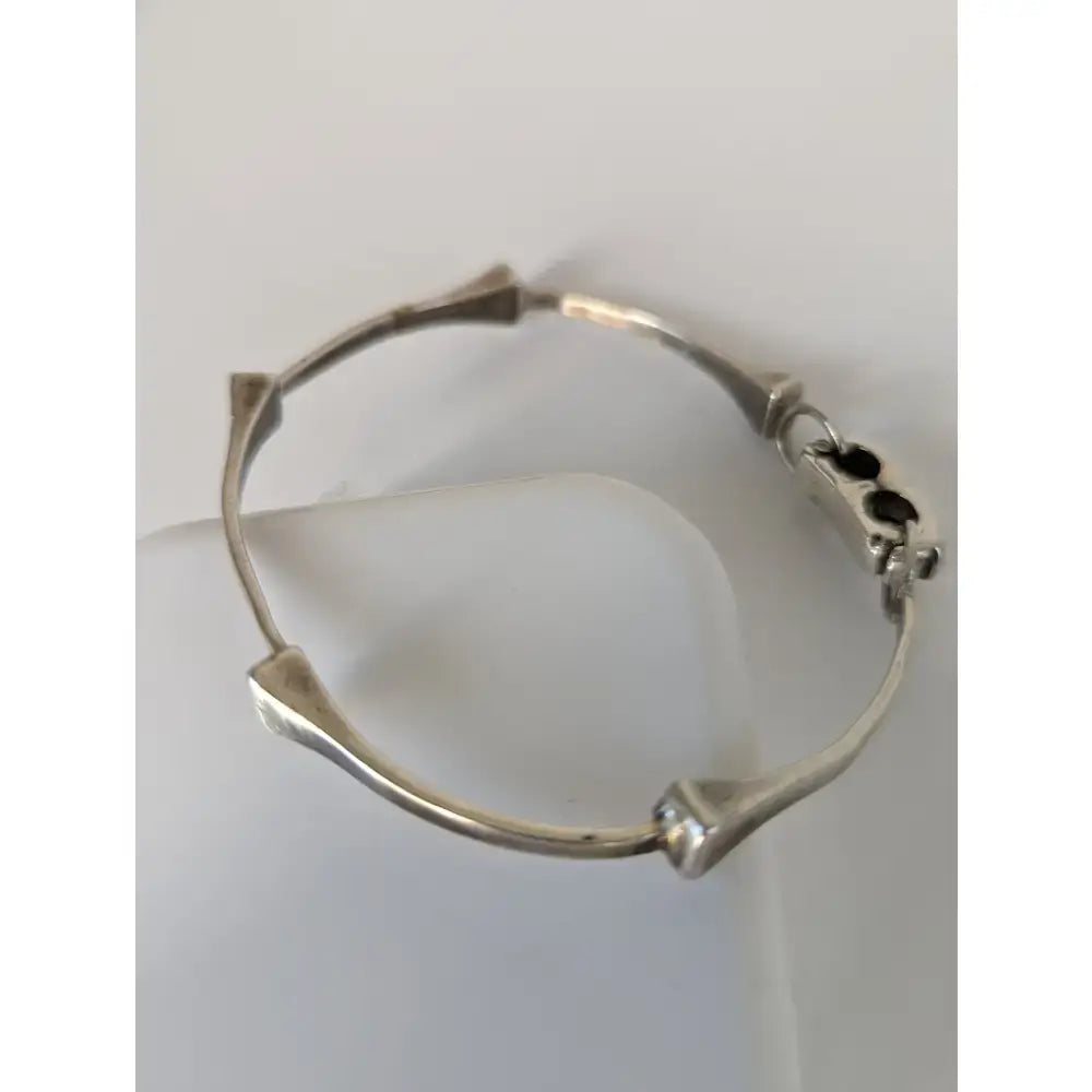 Silver steed sterling silver hoofnails bangle with angular bone-like segments and clasp with three black accents