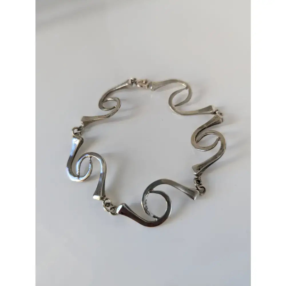 Silver steed hoofnails bracelet with flowing abstract wave links in polished sterling silver finish