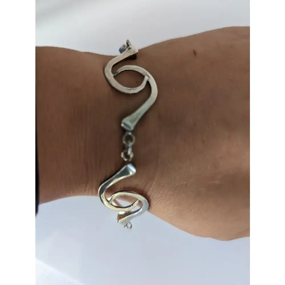 Silver steed sterling silver hoofnails bracelet with flowing abstract curves and central chain link closure