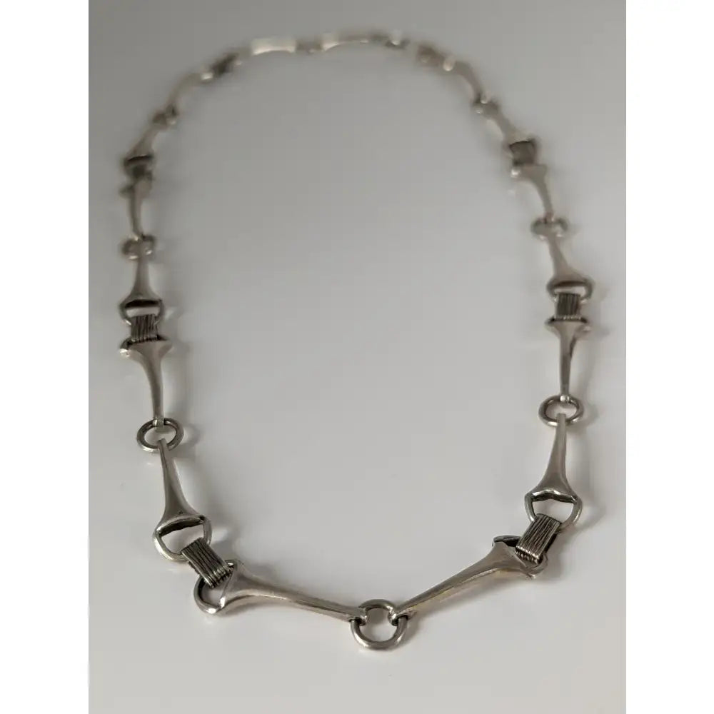 Silver steed snaffle necklace with quality silver, sleek metallic finish, and interlocking horsebit links