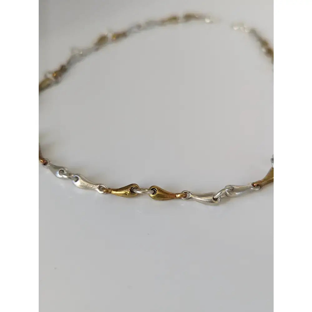 Delicate silver steed snaffle necklace with two-tone silver and gold teardrop links perfect for equestrian style