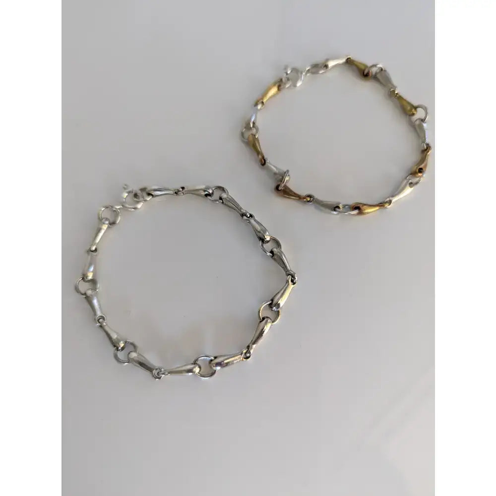 Two silver steed snaffles bracelets with delicate silver and gold-tone mixed-metal horsebit design