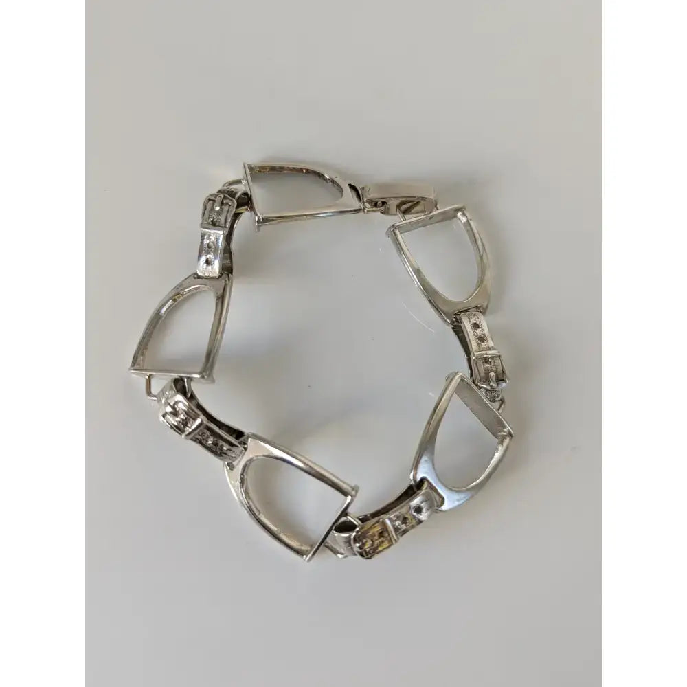 Silver steed stirrups bracelet in silver with diamond accents and a secure clasp featuring equestrian design