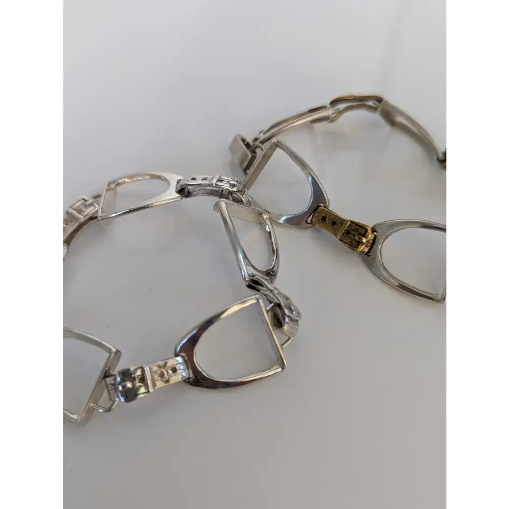 Silver steed stirrups bracelet featuring a silver horsebit design with gold-tone hardware accents and equestrian style