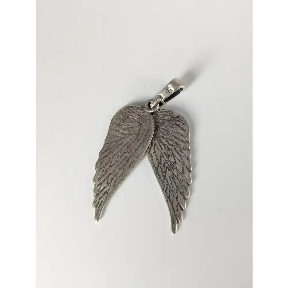 Silver steed angel wings silver pendant with detailed feather texture and polished finish in silver material