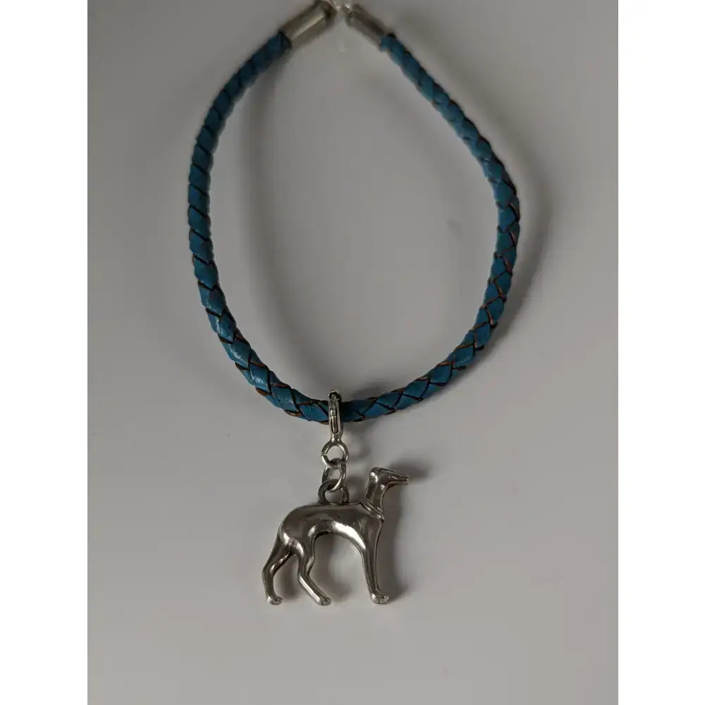 A teal braided leather cord bracelet with a silver steed leather greyhound charm from steed assorted charms collection