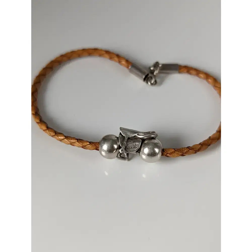 Tan braided leather cord bracelet with silver steed leather horse saddle charm and steed assorted charms beads