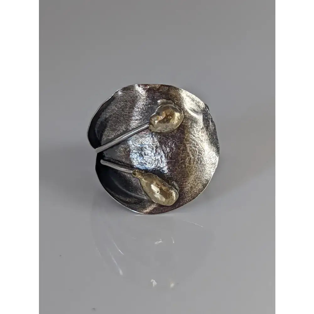 Silver steed big leaf ornament silver ring featuring a silver and gold-toned hammered sterling silver ring with teardrop accents