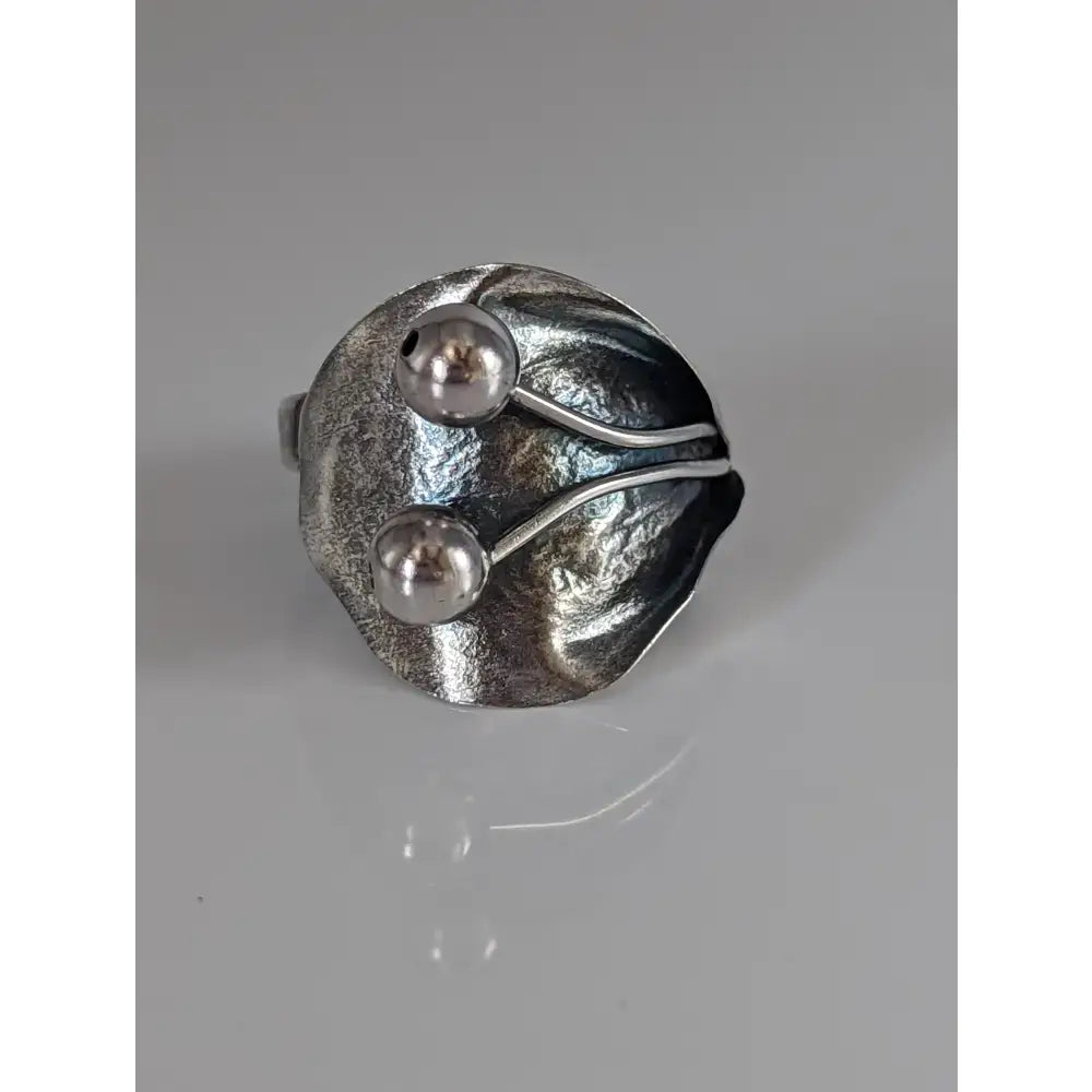 Silver steed big leaf sterling silver ring with silver leaf shape and two polished bead ornaments connected by wire
