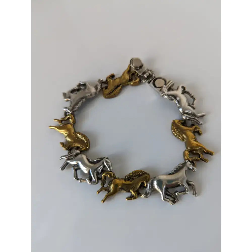 Silver steed galloping horses bracelet with alternating silver and brass horse charms in a dynamic design