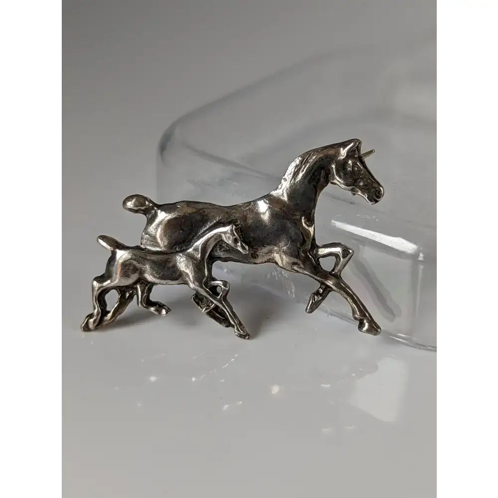Silver steed brood mare brood mare brooch in silver-toned metal showing a mother horse and foal running stock tie pin