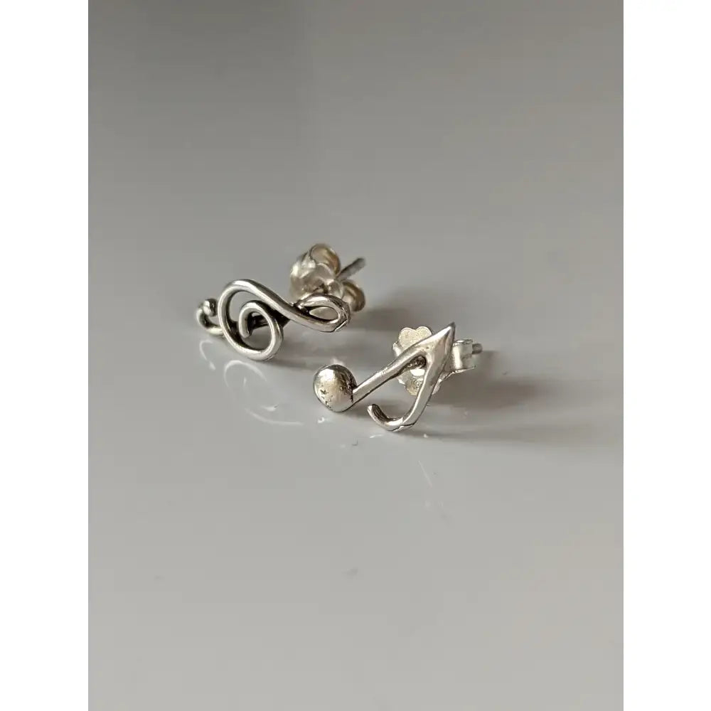 Silver steed celf silver note stud earrings with a polished metallic finish and minimalist celf note design