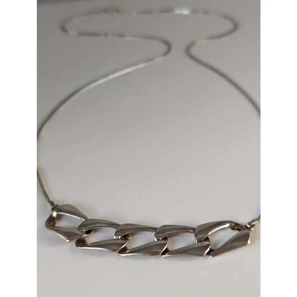 Silver steed chain link necklace made of silver-toned metal with bold geometric links for a stylish chain link necklace look