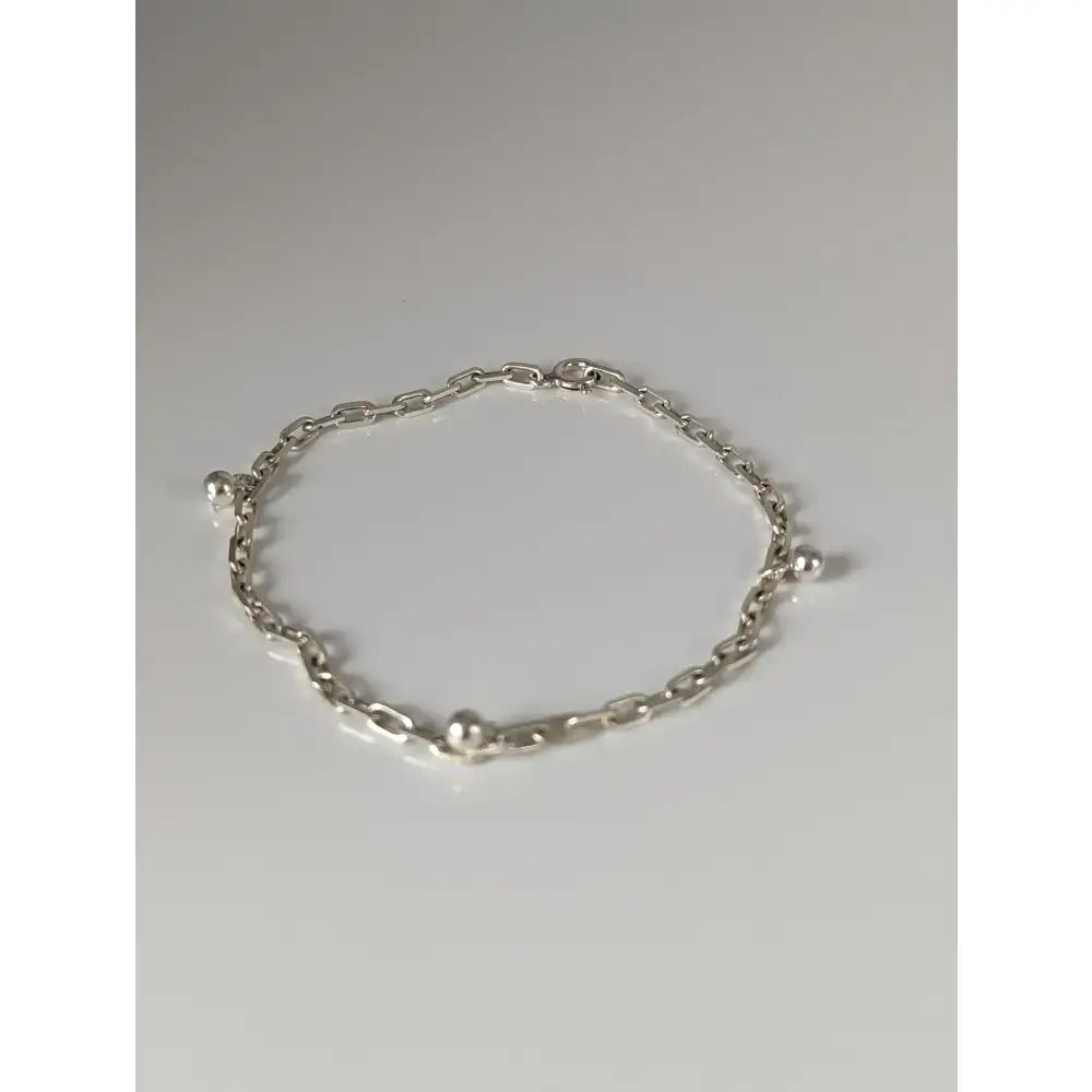 Silver steed chain silver bracelet with small ball charms spaced along a delicate silver chain