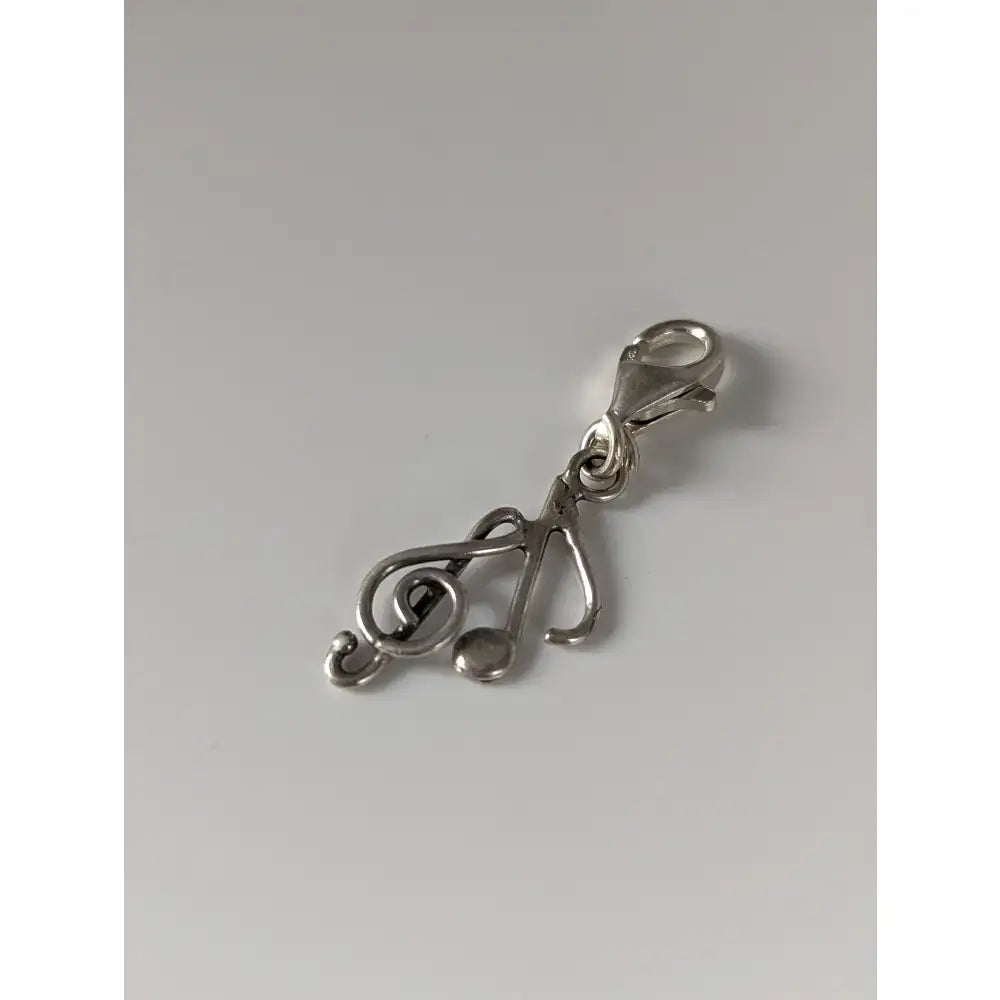 Silver steed clef and note silver charm in silver with treble clef design and lobster clasp for music lovers
