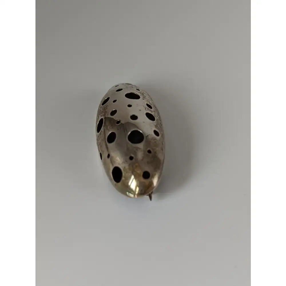 Silver steed coral silver brooch with an oval shape and blackened circular hole pattern for stylish wear