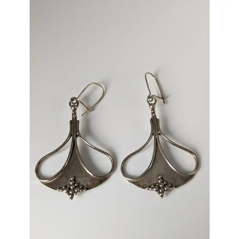 Silver steed crest dropped earrings with teardrop openwork design and small bead accents in silver finish