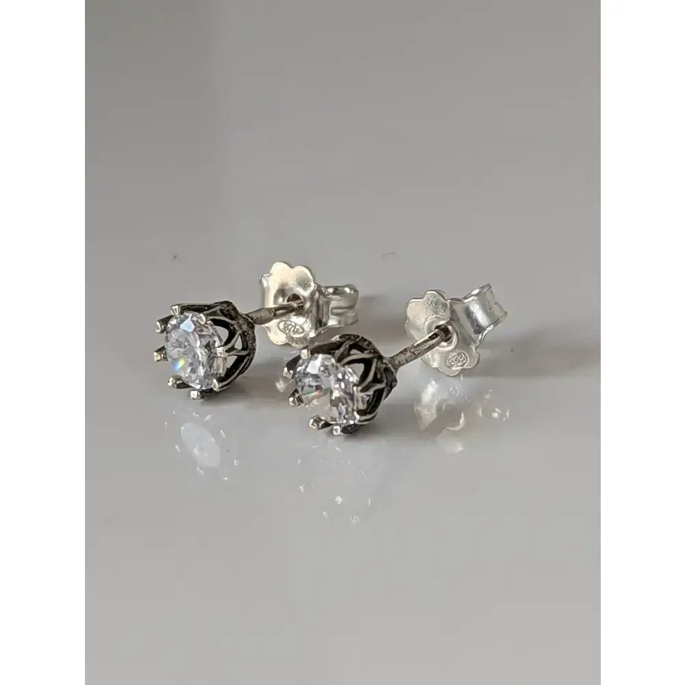 Silver steed crystal crown stud earrings with clear faceted gemstones in blackened metal cage design
