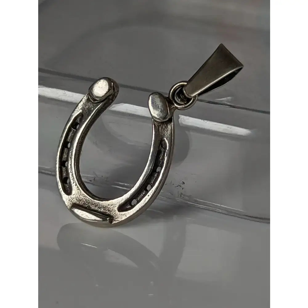 Silver steed pendant featuring polished silver horseshoe jewelry with detailed nail head accents for equestrian silver fans