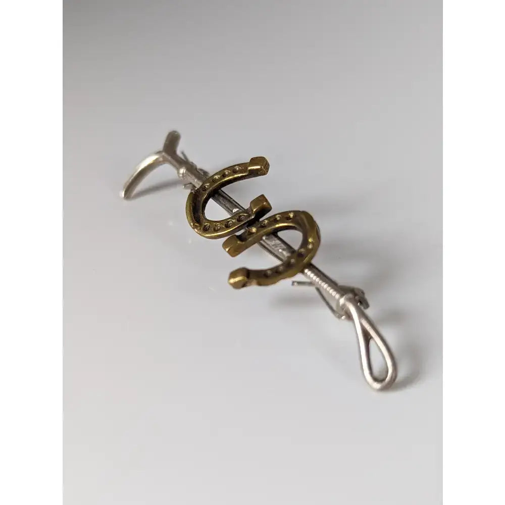 Silver steed double handmade silver cane brooch in silver and gold with small embedded stones in horseshoe shape