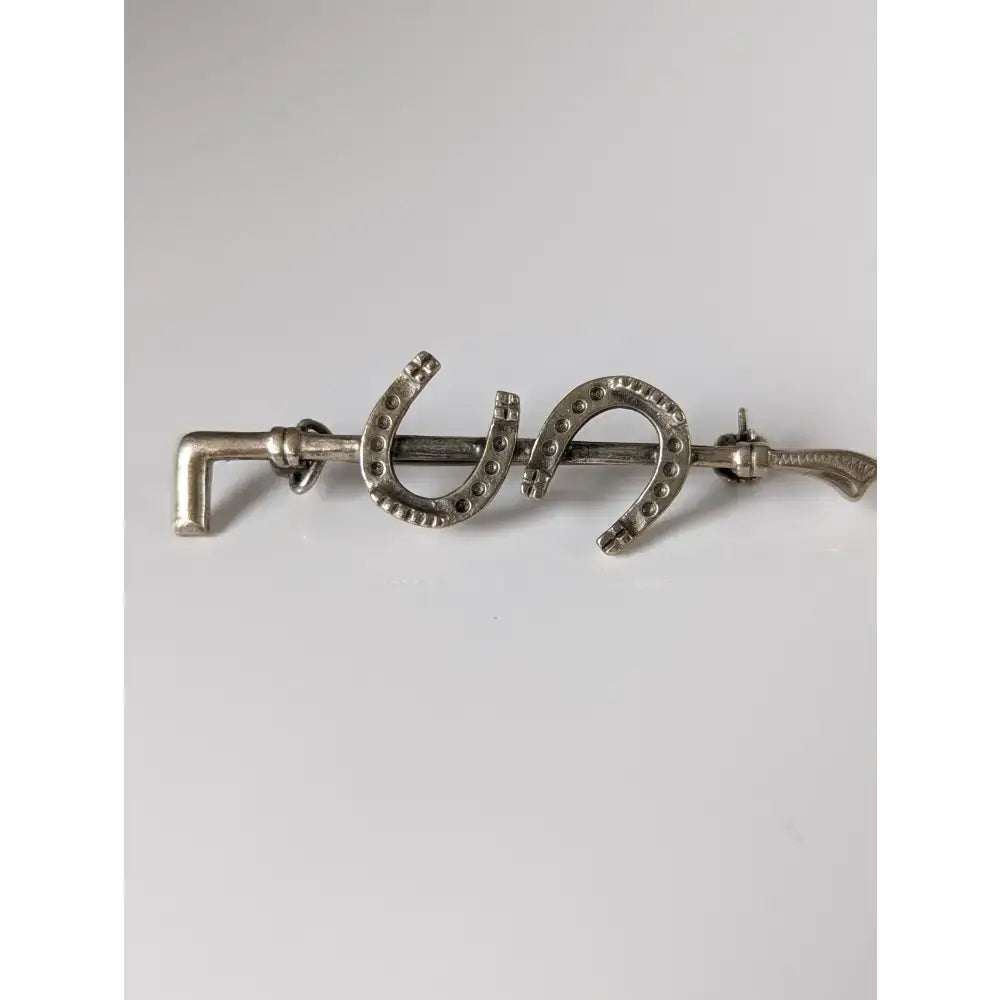 Silver steed double shoe silver brooch with three horseshoe shapes and decorative handles perfect as a stock tie pin