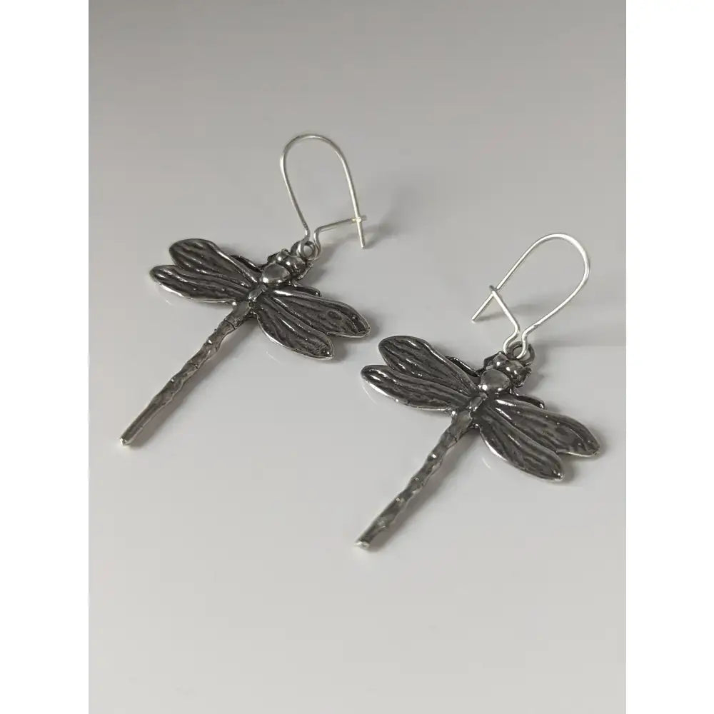 Silver steed dragonfly dropped earrings with handmade silver textured bodies and detailed wings design