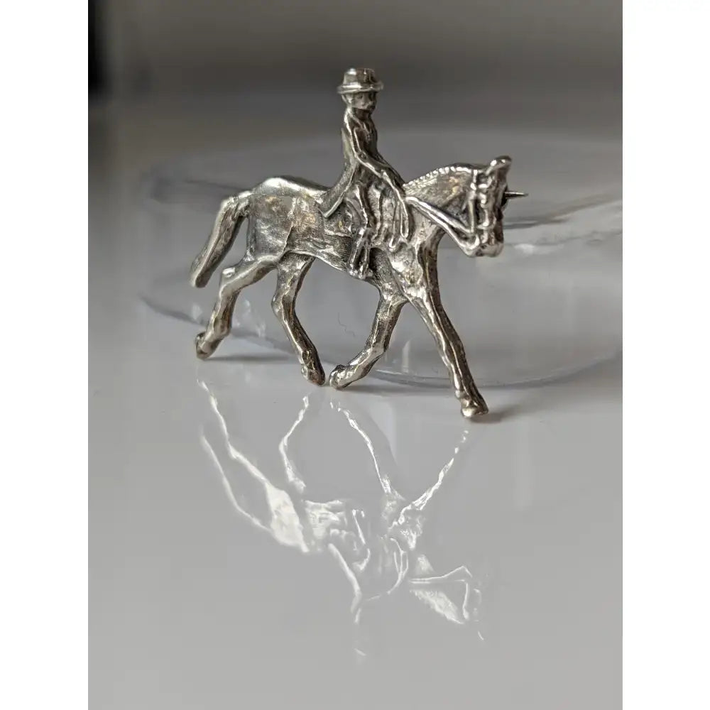 Silver steed dressage brooch showing a handmade silver brooch stock tie pin with rider on detailed horse