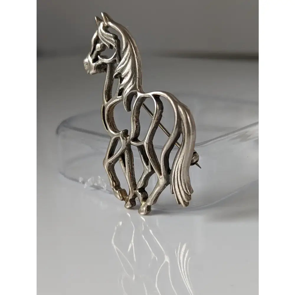 Silver steed elegant piaffe horse silver brooch with intricate cut-out design polished metallic finish