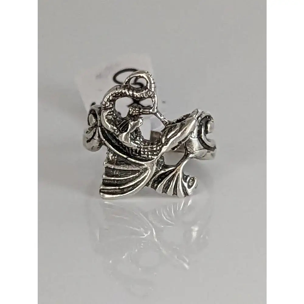 Silver steed fantasy ring featuring a handmade silver band with intricate dragon detailing and textured metallic finish