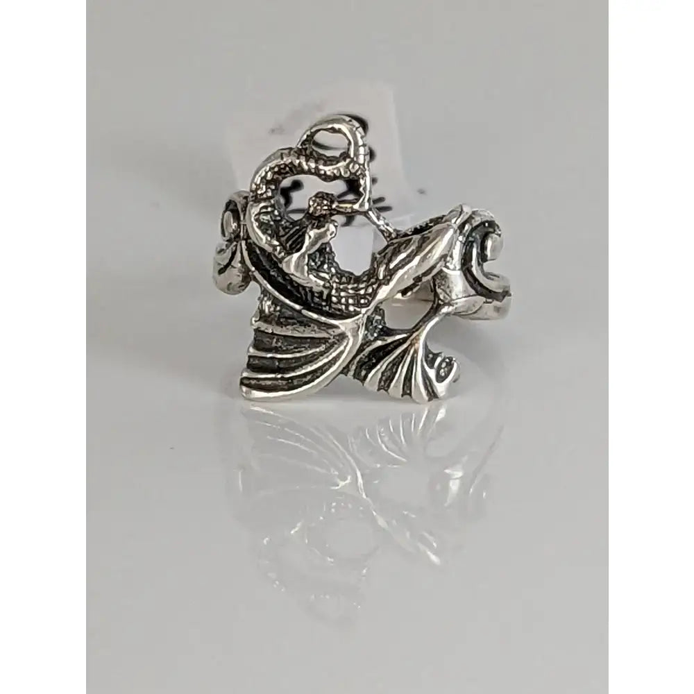 Silver steed fantasy ring with a handmade silver band featuring an intricate silver dragon and fish figurine design