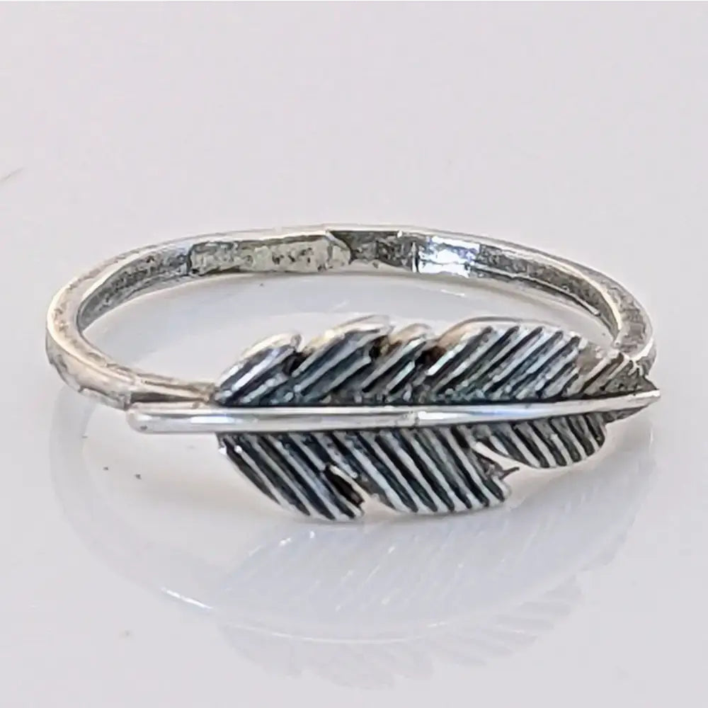 Silver steed feather ring in silver with detailed barbed texture and rustic hand forged finish for a unique look