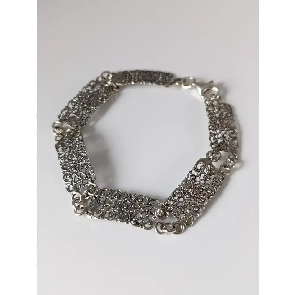 Silver steed filigree vintage silver bracelet with intricate swirling patterns and a secure clasp