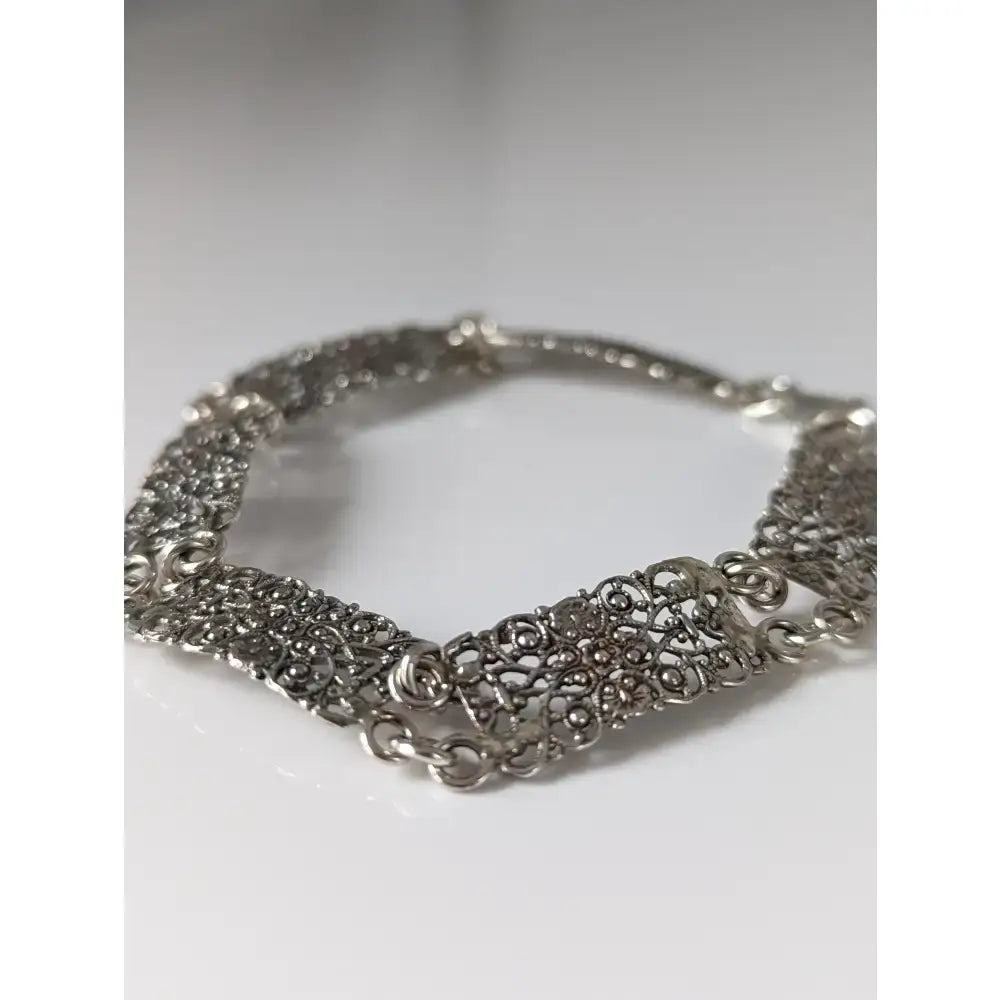 Silver steed filigree vintage silver bracelet with intricate swirling filigree patterns and a delicate chain design
