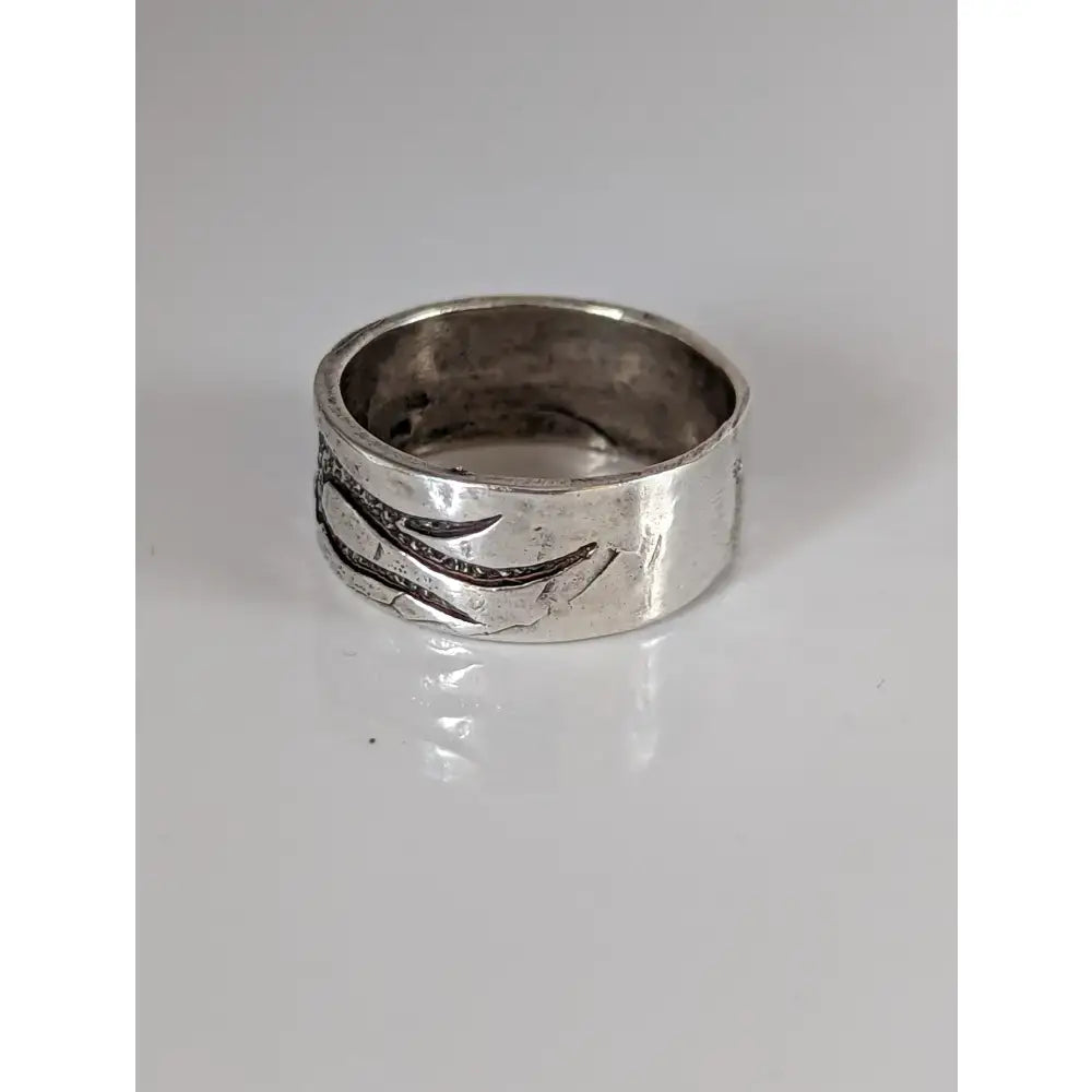 A textured silver band ring with an engraved claw design perfect for silver steed flames equestrian jewelry fans