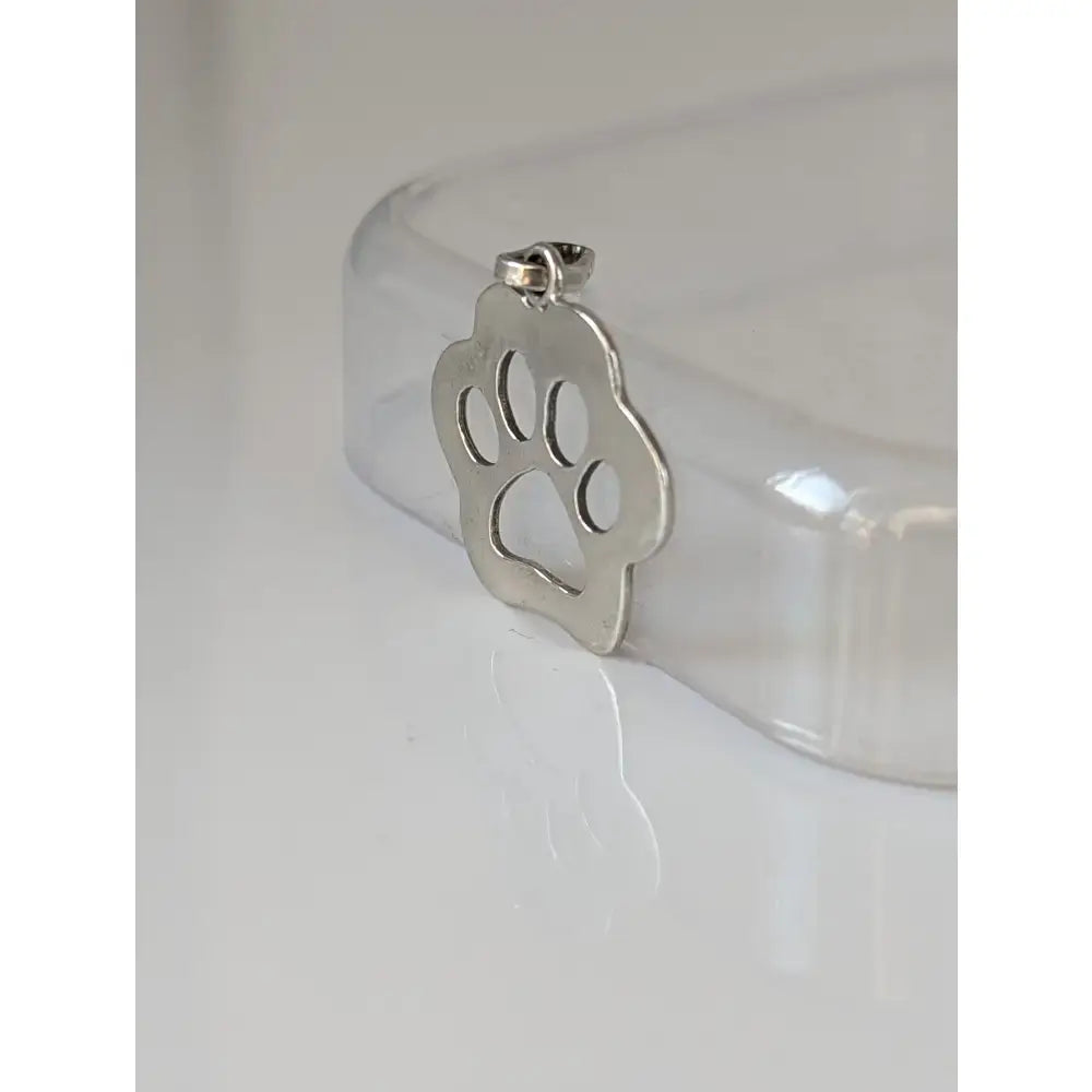 Silver steed flat paw print silver pendant with polished metallic finish and cut-out design for equestrian jewelry fans