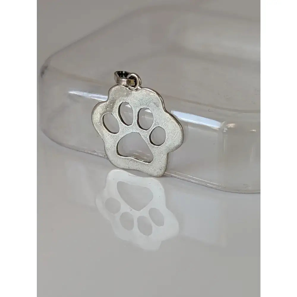 Silver steed flat polished silver pendant with reflective cut-out paw print design perfect for equestrian jewelry fans