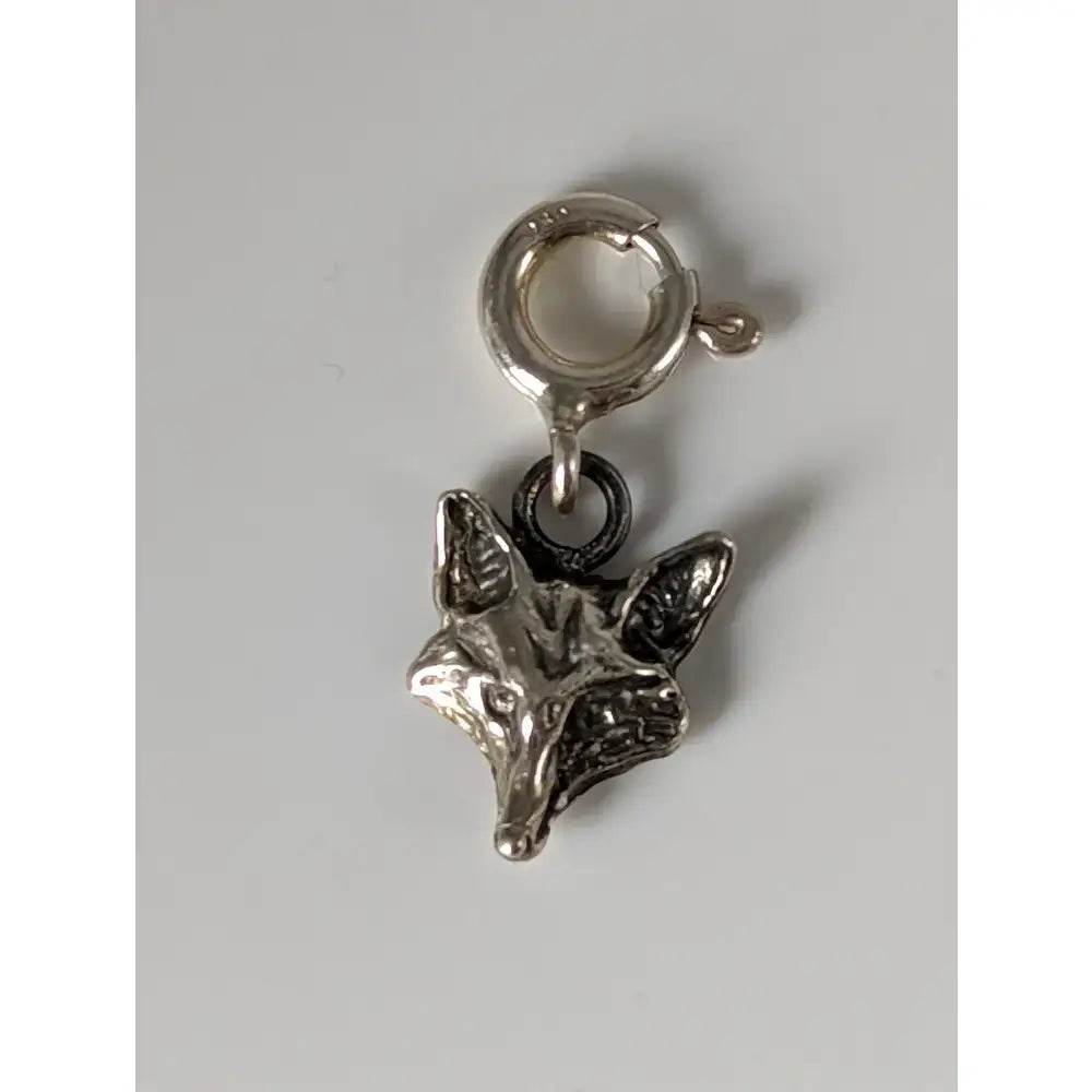 Silver steed fox head silver charm with detailed face and pointed ears on a matching silver clasp for equestrian jewelry